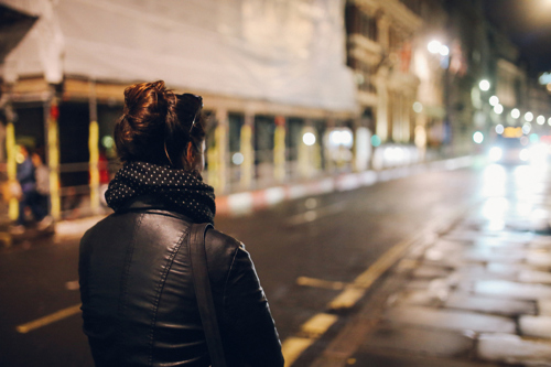 traveller on the street by herself in the evening
